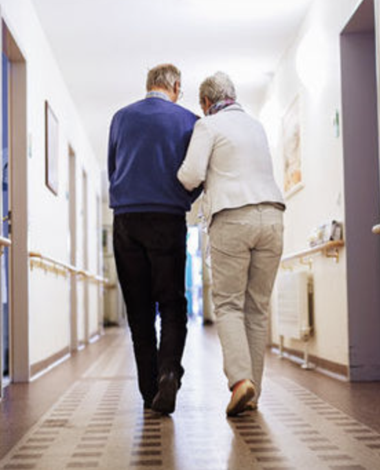 A resident walking the hallway with a companion