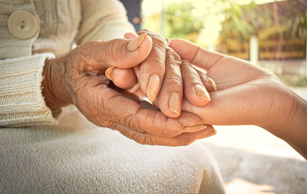 Caregivers attending to residents in a warm common area